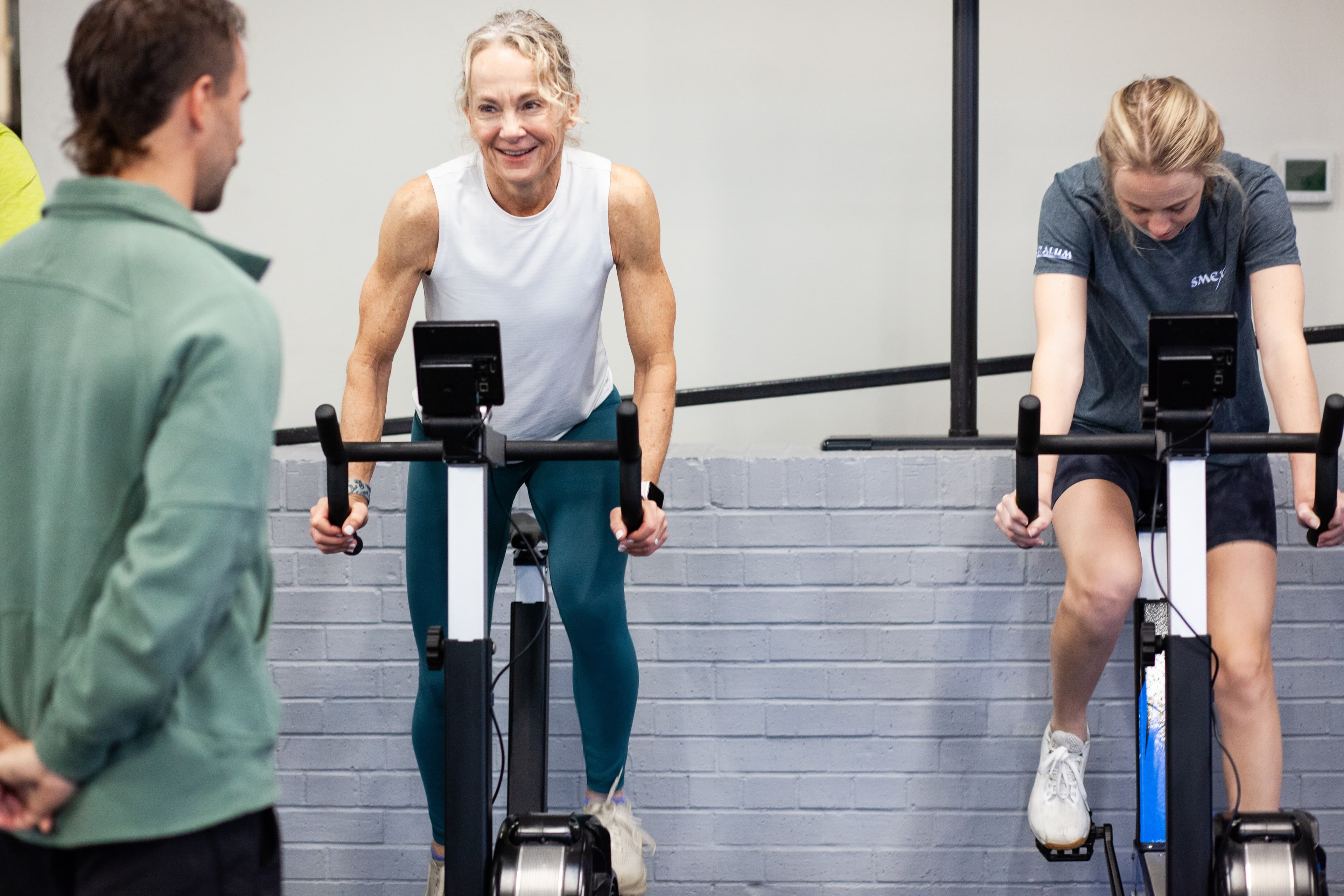 Members training on the assault bikes